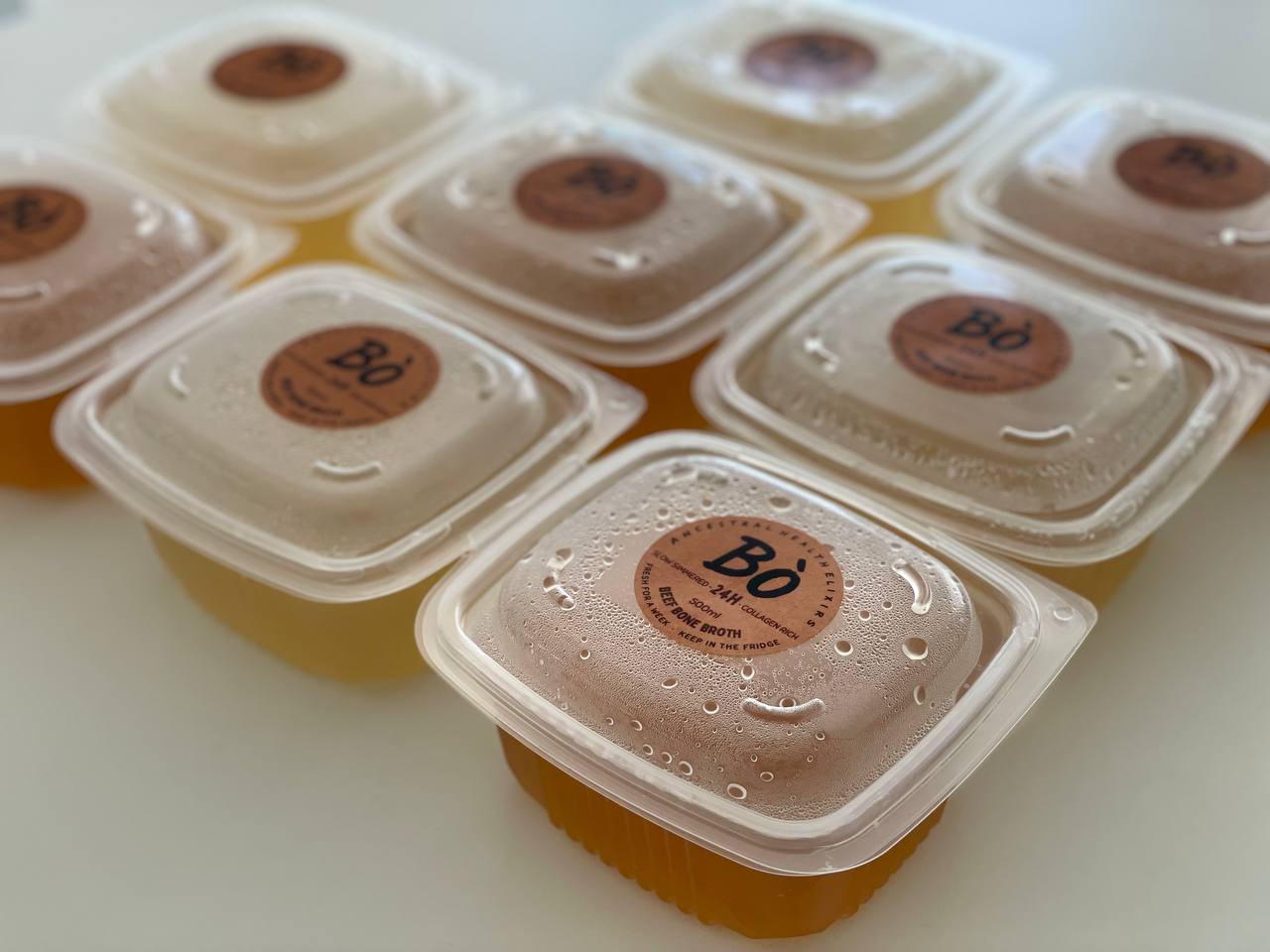 Multiple Bò containers showing consistent gelatinous quality across the batch